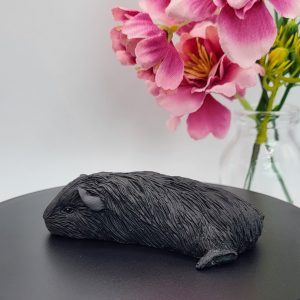 Sleeping black guinea pig figurine