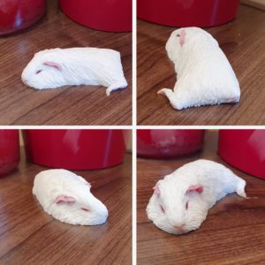Sleeping white guinea pig figurine