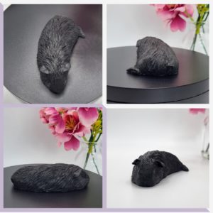 Sleeping black guinea pig figurine